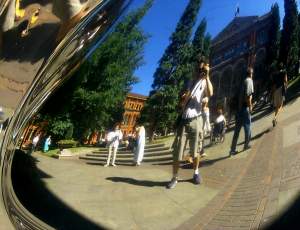 A photo of the shaded courtyard reflected in an aluminium sculpture