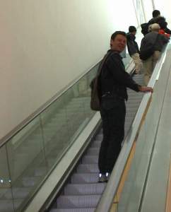 Neil receding up the escalator at the National Portrait Gallery.