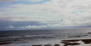 Looking out to sea from the beach: a passenger ferry from Scandinavia can just be seen way out.
