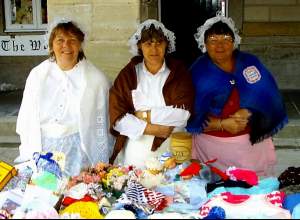 Three woman trying to sell their home-knits at Alnwick Fair.