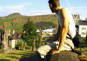 A beautiful, peaceful cemetery, with the massive hill right next to downtown, Arthur's Seat, in
the background. The cranes at the right are in the construction site for Scotland's new parliament
buildings.