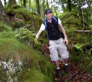 Hiking back down hill through the rocks and dense trees.