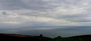 Looking out to sea, not long before sunset, from the heights of Exmoor. The clouds were casting
a misty white streak through the sea.