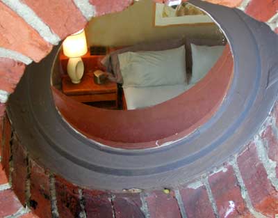 The porthole was there long before the deck was built atop the neighboring building that afforded
this rather intimate, accidental view
